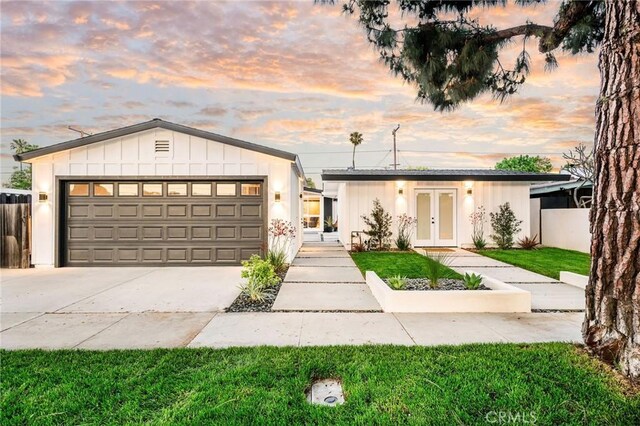 3130 Kallin Ave, Long Beach, CA 90808 - view of front of property featuring french doors, a garage, fence, concrete driveway, and board and batten siding