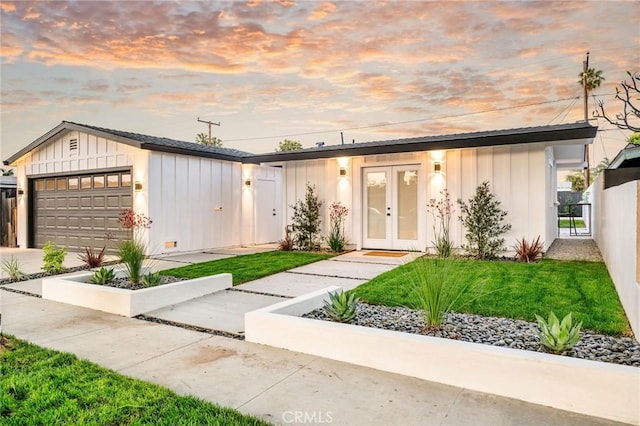 3130 Kallin Ave, Long Beach, CA 90808 - view of front of home featuring board and batten siding, french doors, an attached garage, and concrete driveway