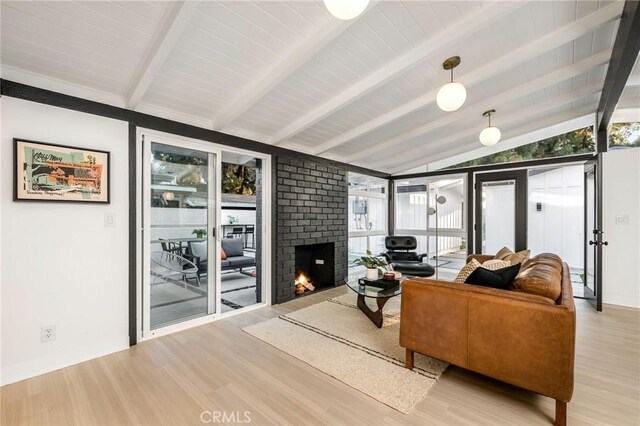 3130 Kallin Ave, Long Beach, CA 90808 - living room with wood finished floors, a brick fireplace, and baseboards
