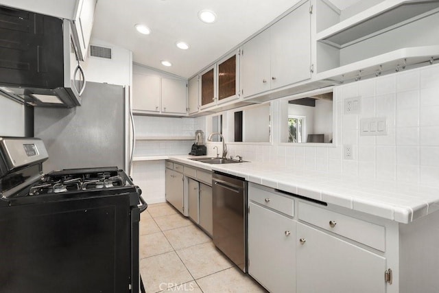 1229 Kilson Dr, Santa Ana, CA 92707 - kitchen with appliances with stainless steel finishes, a sink, decorative backsplash, light tile patterned floors, and recessed lighting
