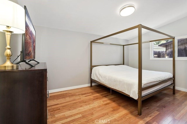 1229 Kilson Dr, Santa Ana, CA 92707 - bedroom featuring light wood finished floors, lofted ceiling, and baseboards