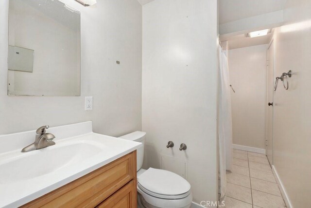 1229 Kilson Dr, Santa Ana, CA 92707 - full bath with tile patterned floors, vanity, toilet, and a shower with shower curtain