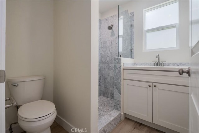 1271 S Sycamore Ave, Los Angeles, CA 90019 - bathroom with a walk in shower, toilet, wood finished floors, and vanity