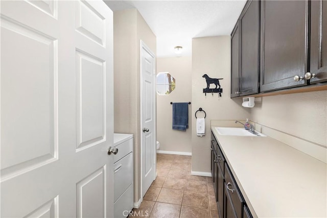 bathroom featuring vanity, toilet, tile patterned floors, and baseboards