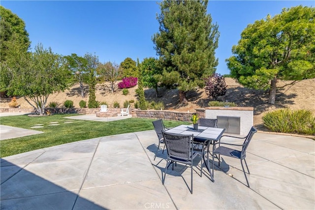 view of patio with outdoor dining area and a fire pit