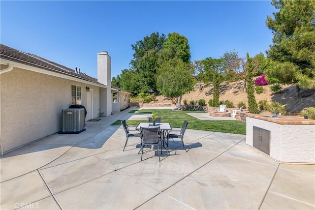 view of patio with cooling unit and outdoor dining area