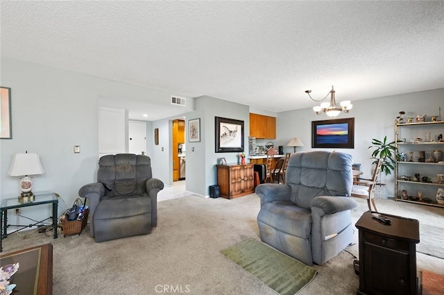 living area with light colored carpet, an inviting chandelier, a textured ceiling, and visible vents