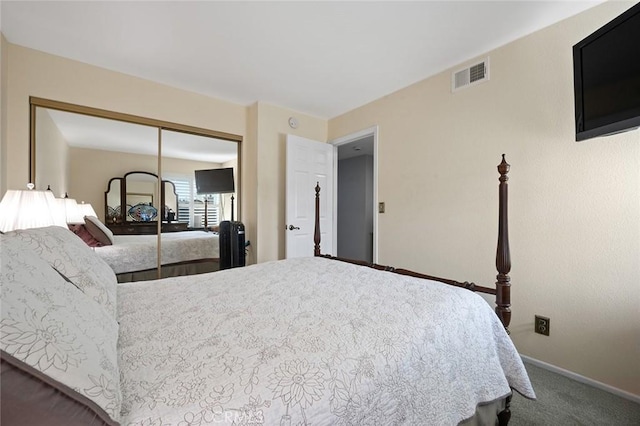 bedroom with carpet flooring, baseboards, a closet, and visible vents