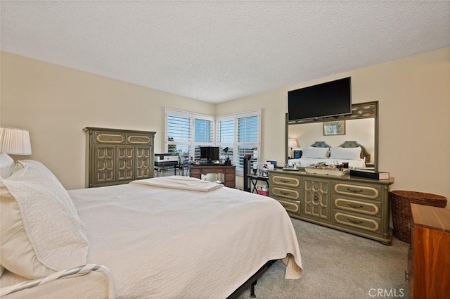 bedroom with a textured ceiling and carpet floors