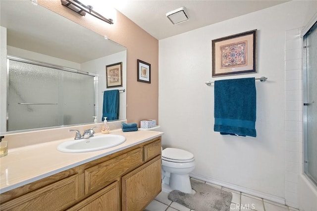 full bath featuring a shower with shower door, vanity, toilet, and tile patterned floors
