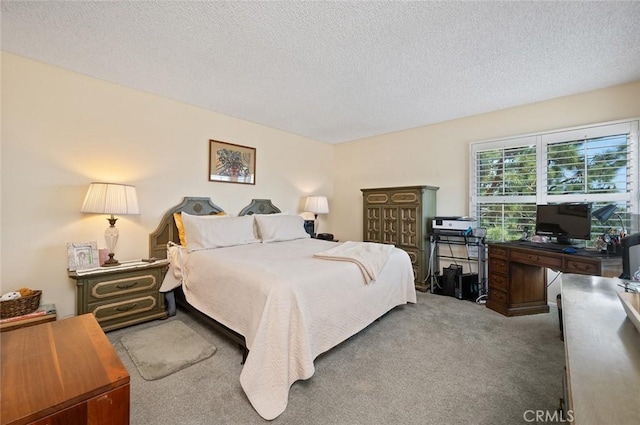 bedroom with a textured ceiling and carpet flooring