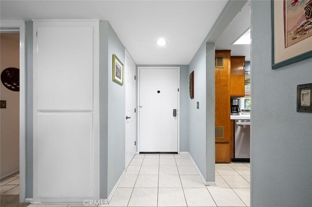 hallway with baseboards, recessed lighting, visible vents, and light tile patterned flooring