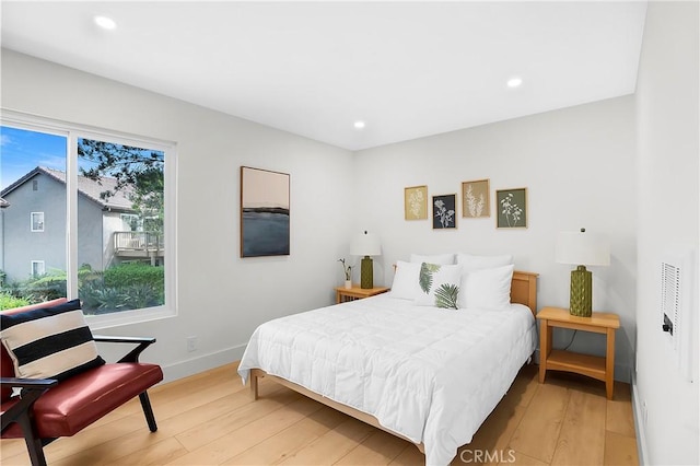bedroom with light wood finished floors, baseboards, and recessed lighting