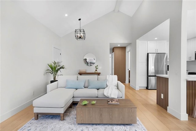 living area featuring light wood finished floors, baseboards, beamed ceiling, and high vaulted ceiling