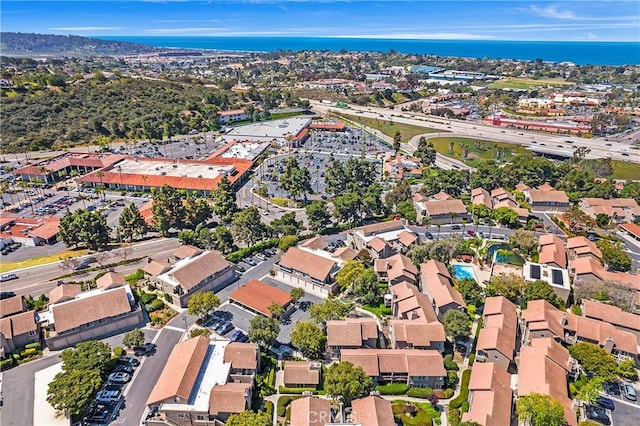 drone / aerial view with a water view and a residential view