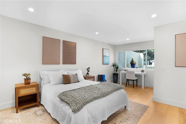 bedroom with baseboards, light wood-style flooring, and recessed lighting