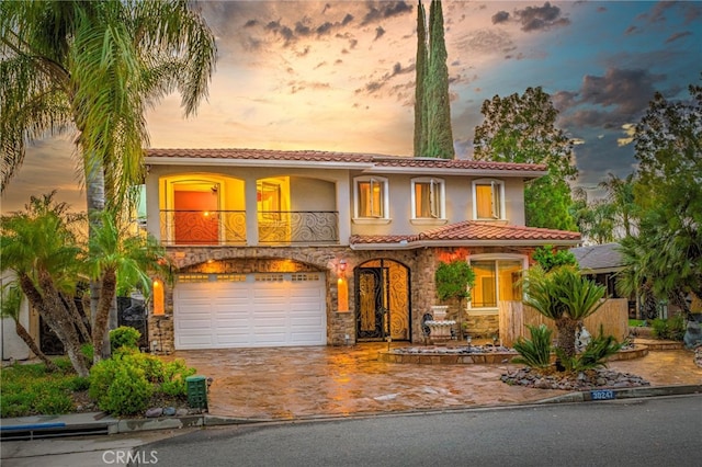 30247 Yellow Feather Dr, Canyon Lake, CA 92587 - mediterranean / spanish-style home with stone siding, a tiled roof, driveway, and an attached garage
