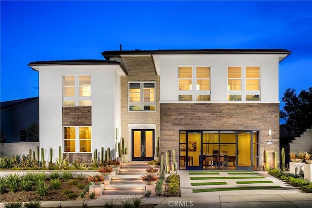 27780 Reel Ln, Valencia, CA 91381 - back of house featuring stone siding, stucco siding, and french doors