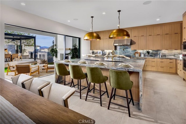 27780 Reel Ln, Valencia, CA 91381 - kitchen with wall chimney range hood, oven, modern cabinets, and light brown cabinetry