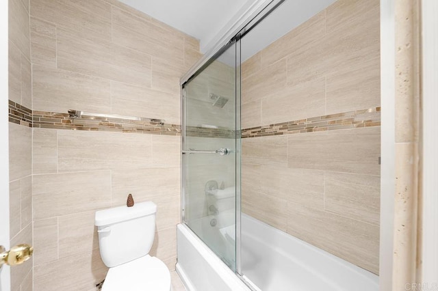 full bath with toilet and shower / bath combination with glass door