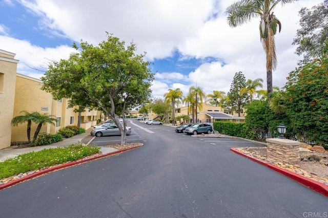 view of street featuring a residential view, curbs, and sidewalks