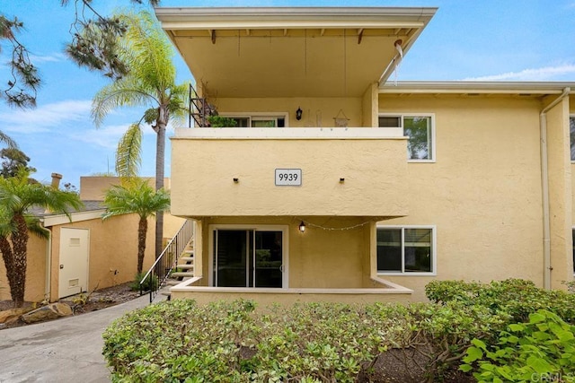 rear view of property with stucco siding