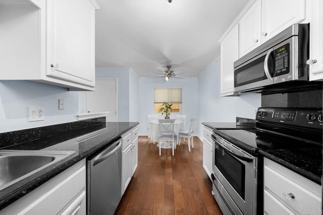 9939 Erma Rd Unit 101, San Diego, CA 92131 - kitchen with dark wood-style flooring, ceiling fan, a sink, white cabinetry, and appliances with stainless steel finishes