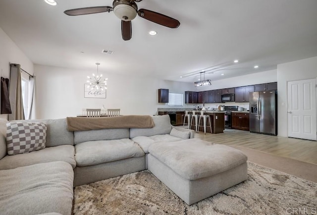 26841 Franklin Ave, Winchester, CA 92596 - living area featuring light wood-style flooring, ceiling fan with notable chandelier, visible vents, and recessed lighting