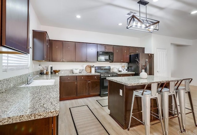 26841 Franklin Ave, Winchester, CA 92596 - kitchen featuring a sink, range with gas cooktop, stainless steel fridge with ice dispenser, visible vents, and black microwave