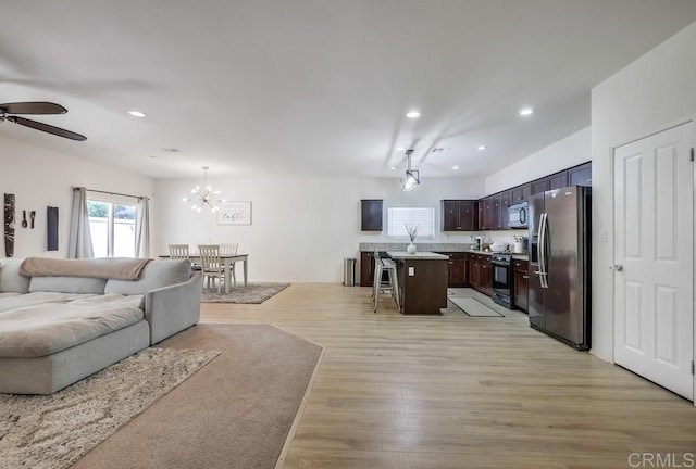 26841 Franklin Ave, Winchester, CA 92596 - living room featuring light wood-type flooring, ceiling fan with notable chandelier, and recessed lighting