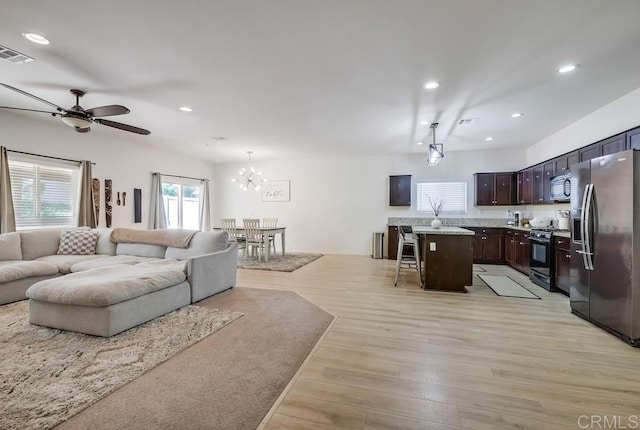 26841 Franklin Ave, Winchester, CA 92596 - living room featuring light wood-style floors, ceiling fan with notable chandelier, visible vents, and recessed lighting