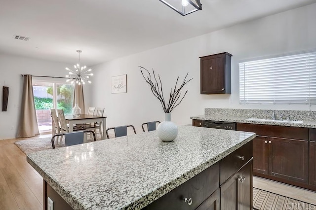 26841 Franklin Ave, Winchester, CA 92596 - kitchen with black dishwasher, visible vents, a sink, a chandelier, and light wood-style floors