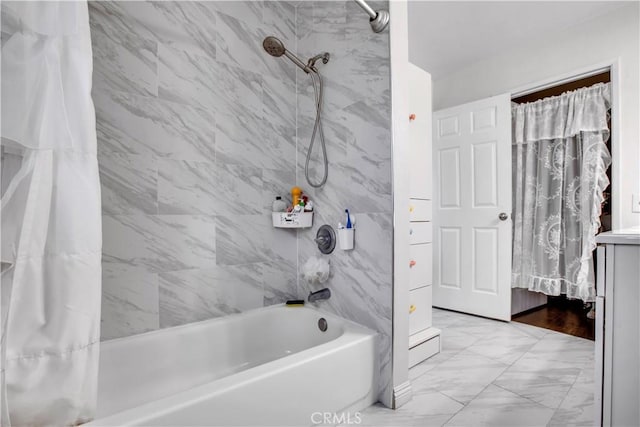full bath with marble finish floor and shower / tub combo with curtain