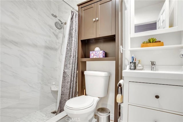 full bathroom with a stall shower, vanity, and toilet