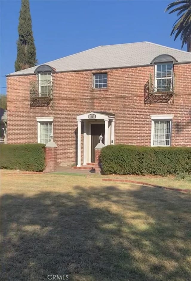 1525 N Arrowhead Ave, San Bernardino, CA 92405 - view of front facade featuring brick siding and a front yard