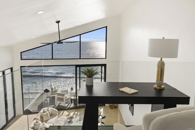 office space featuring plenty of natural light, a water view, and wood finished floors