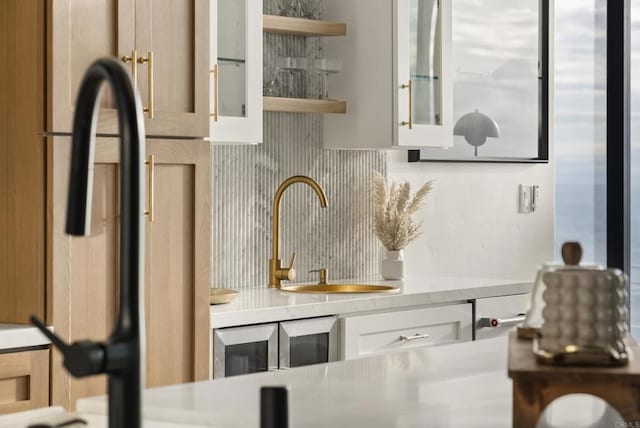 bar featuring decorative backsplash and a sink