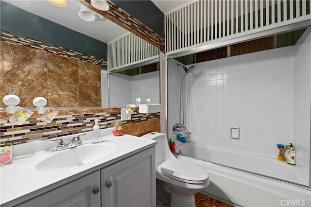 full bathroom featuring tub / shower combination, toilet, backsplash, and vanity
