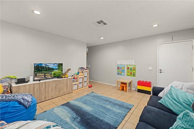 playroom featuring light tile patterned floors, recessed lighting, visible vents, and a textured ceiling