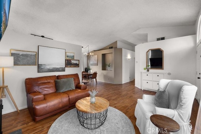 1009 Fairwind Ave, Rosamond, CA 93560 - living room with lofted ceiling, a notable chandelier, visible vents, and wood finished floors