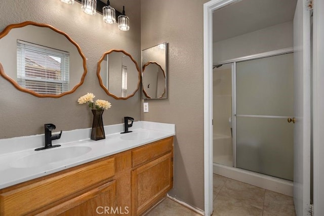 1009 Fairwind Ave, Rosamond, CA 93560 - bathroom featuring a sink, tile patterned flooring, and a shower stall