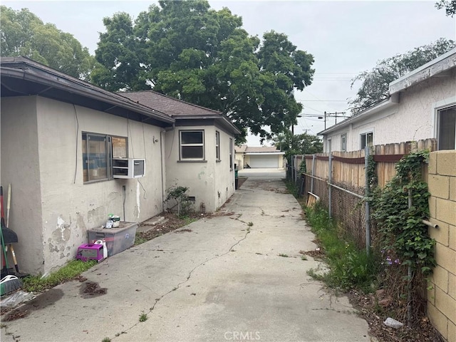 3754 Grace Ave, Baldwin Park, CA 91706 - view of home's exterior featuring cooling unit, stucco siding, fence, and a garage