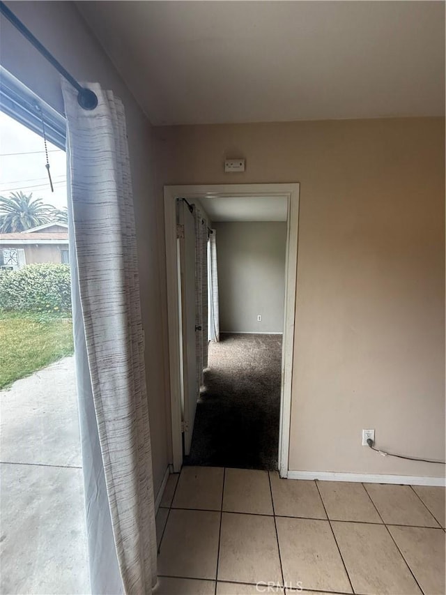 3754 Grace Ave, Baldwin Park, CA 91706 - hallway with baseboards and light tile patterned floors