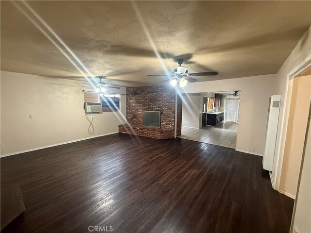 3754 Grace Ave, Baldwin Park, CA 91706 - unfurnished living room featuring wood finished floors, a fireplace, ceiling fan, an AC wall unit, and baseboards