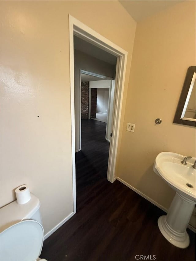 3754 Grace Ave, Baldwin Park, CA 91706 - bathroom with toilet, baseboards, and wood finished floors