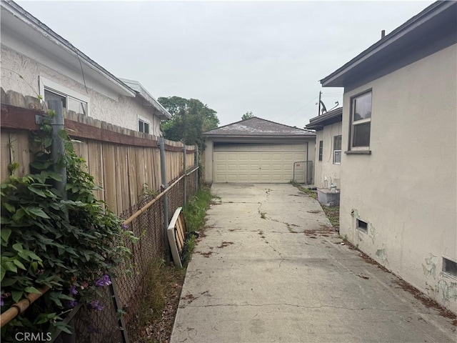 3754 Grace Ave, Baldwin Park, CA 91706 - view of side of home with an outbuilding, stucco siding, a garage, and fence