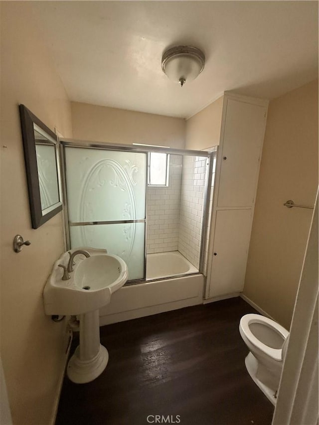 3754 Grace Ave, Baldwin Park, CA 91706 - bathroom featuring a sink, toilet, shower / bath combination with glass door, and wood finished floors