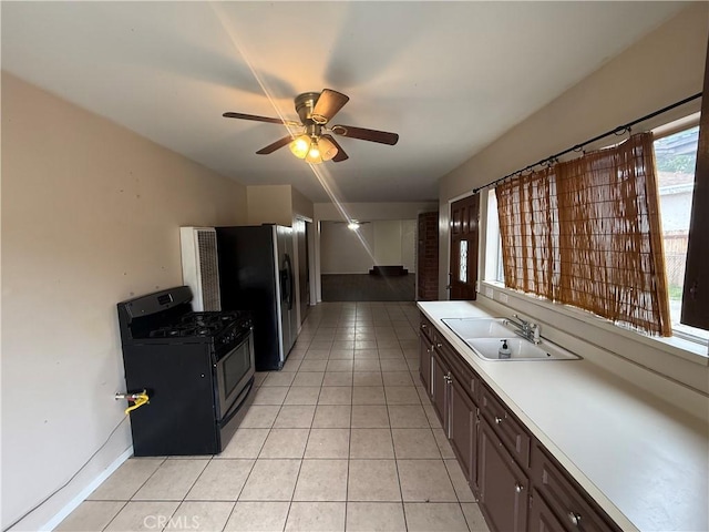 3754 Grace Ave, Baldwin Park, CA 91706 - kitchen with a sink, light tile patterned flooring, light countertops, a ceiling fan, and range with gas cooktop