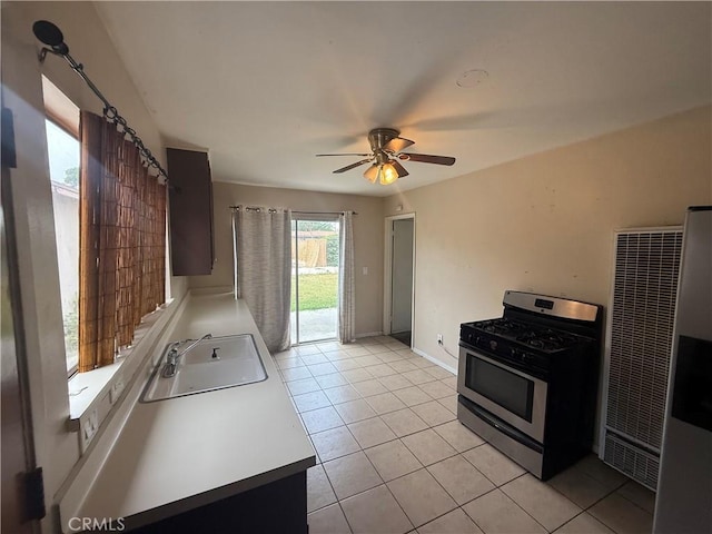 3754 Grace Ave, Baldwin Park, CA 91706 - kitchen featuring light tile patterned floors, a ceiling fan, a sink, a heating unit, and gas range