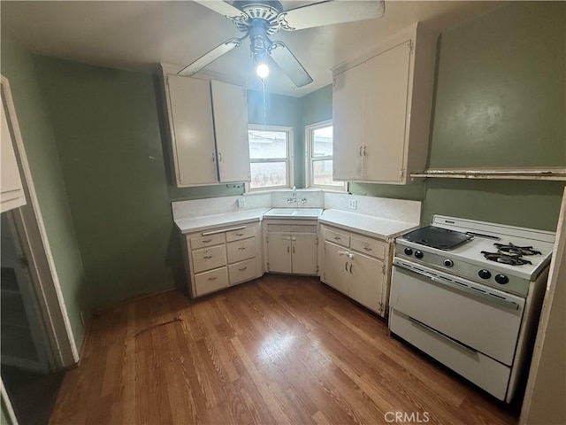 3754 Grace Ave, Baldwin Park, CA 91706 - kitchen with light countertops, gas range gas stove, ceiling fan, and wood finished floors